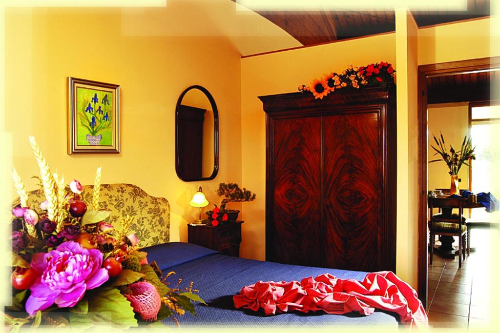 Postel nebo postele na pokoji v ubytování Agriturismo Cavendo Tutus