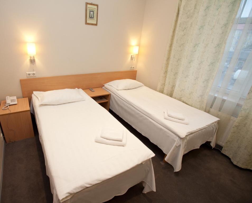 Postel nebo postele na pokoji v ubytování TOSS Hotel