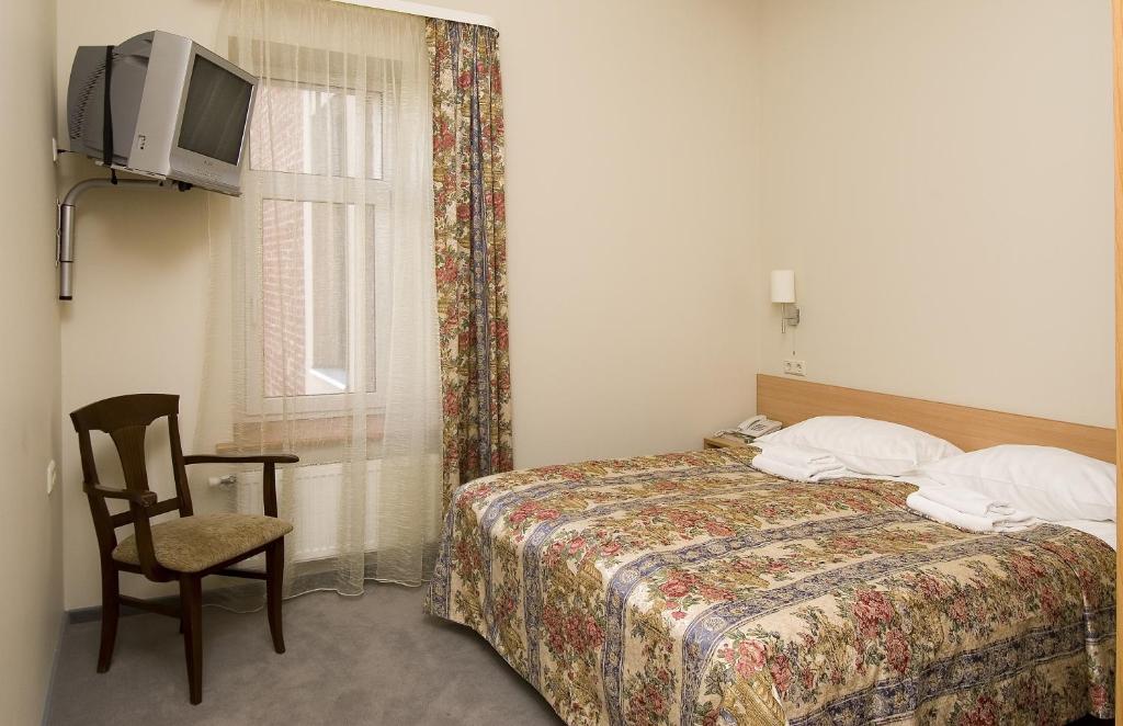 Postel nebo postele na pokoji v ubytování TOSS Hotel