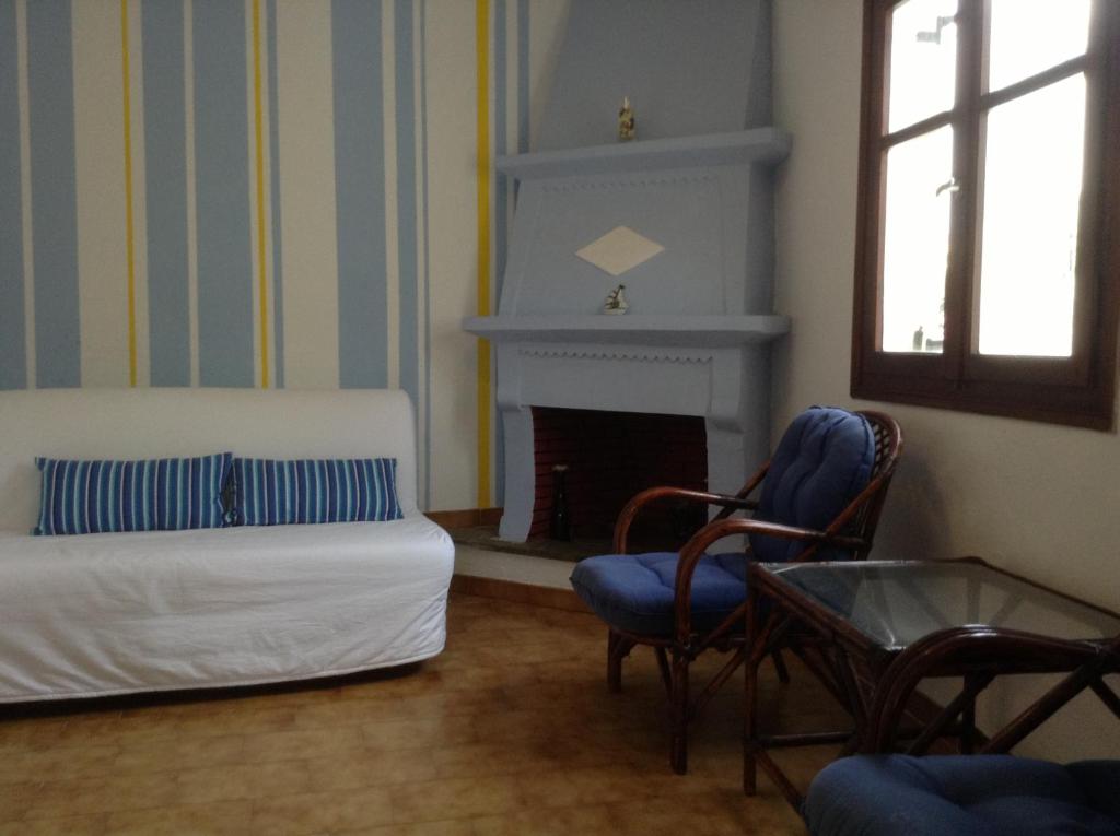 a living room with a bed and a fireplace at Studios LaLu in Skiathos