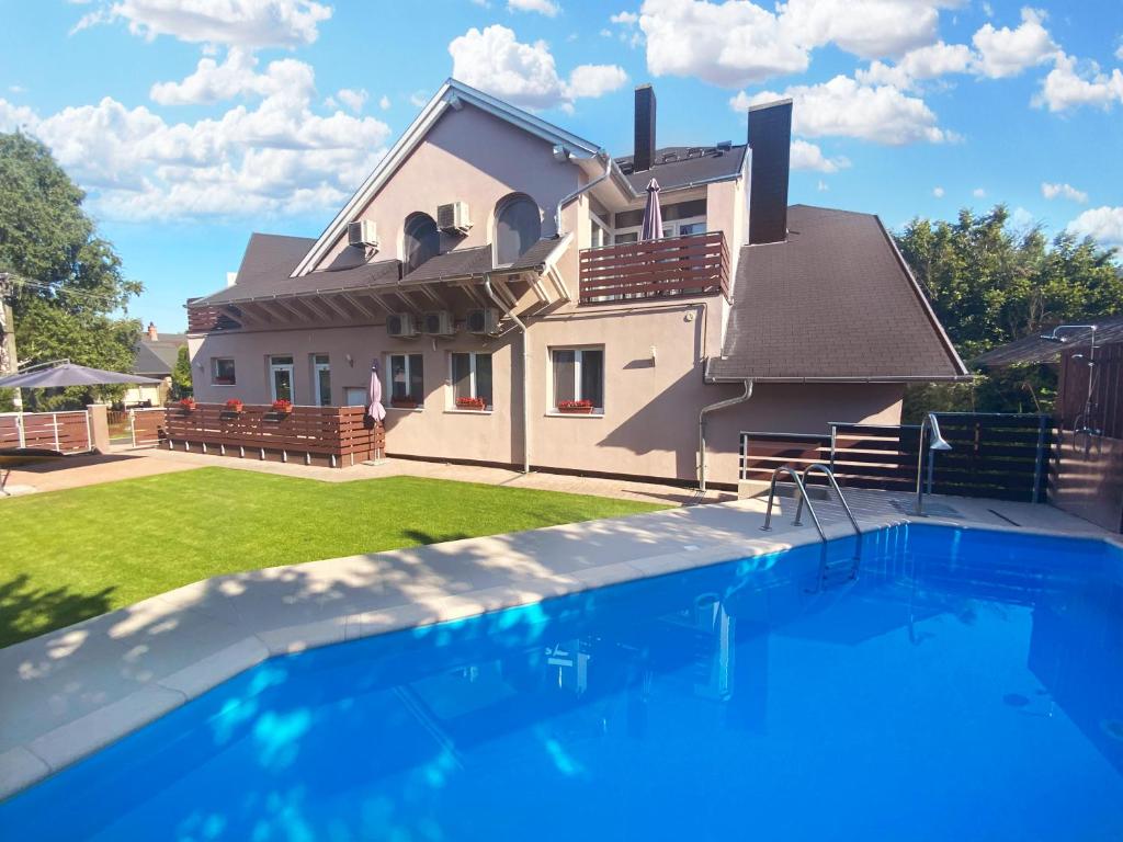 a house with a swimming pool in front of a house at TópART Apartman II in Balatonfenyves