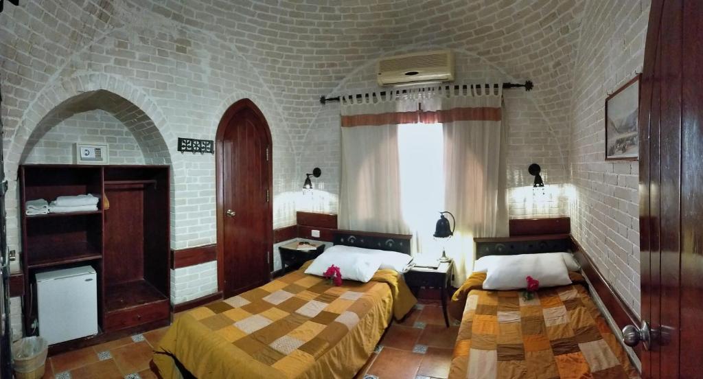 A bed or beds in a room at Nesima Resort
