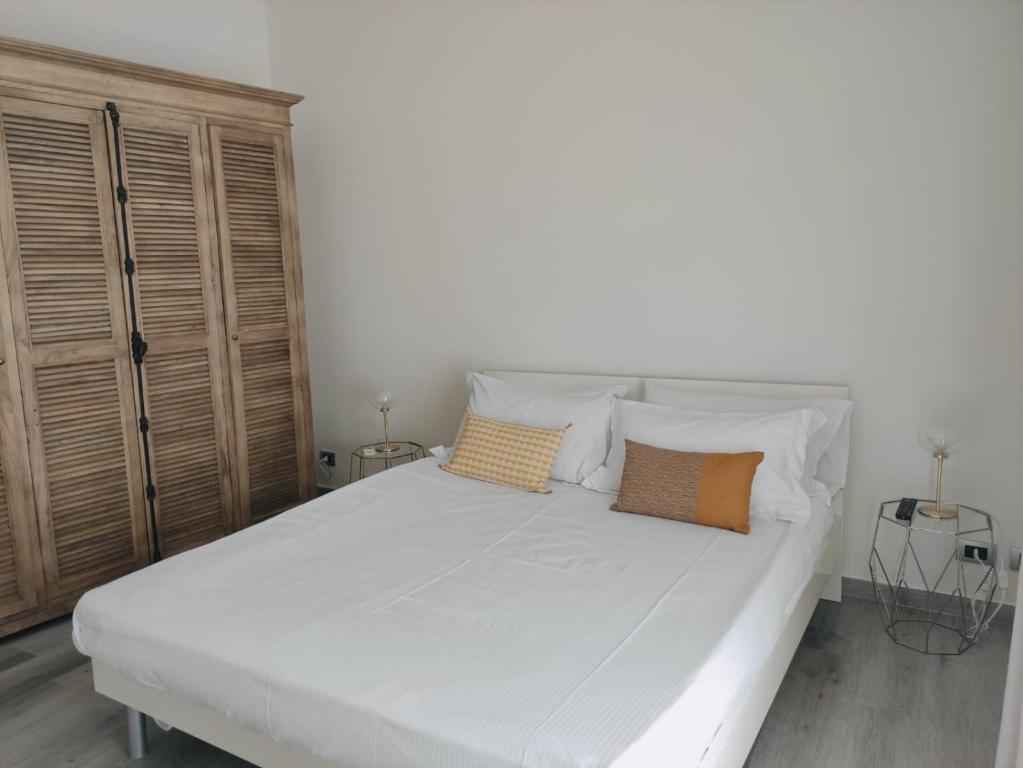 a bedroom with a large white bed with two pillows at Ostro - Guest House in Agrigento