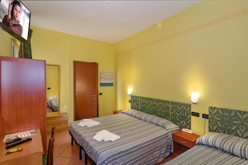 Postel nebo postele na pokoji v ubytování Hotel Villa Colombo