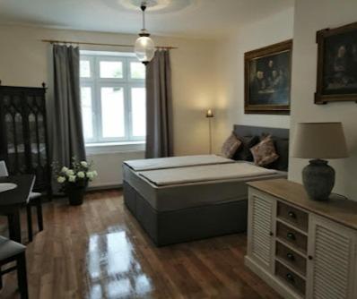 a living room with a bed and a window at Apartmán Praha Břevnov in Prague