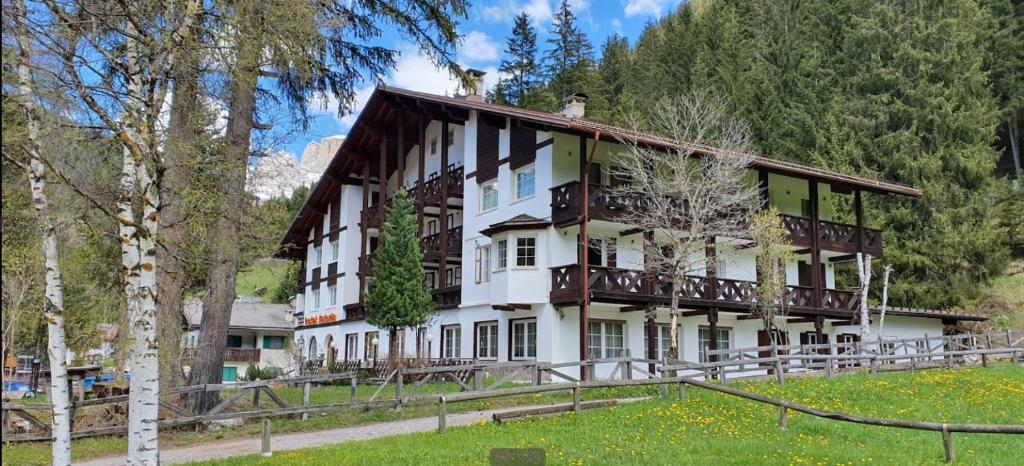 a large white building with a balcony at Park Hotel Faloria in Canazei