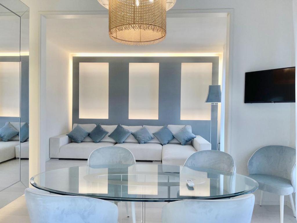 a living room with a glass table and a couch at Luxury Home Paradise View in Forte dei Marmi
