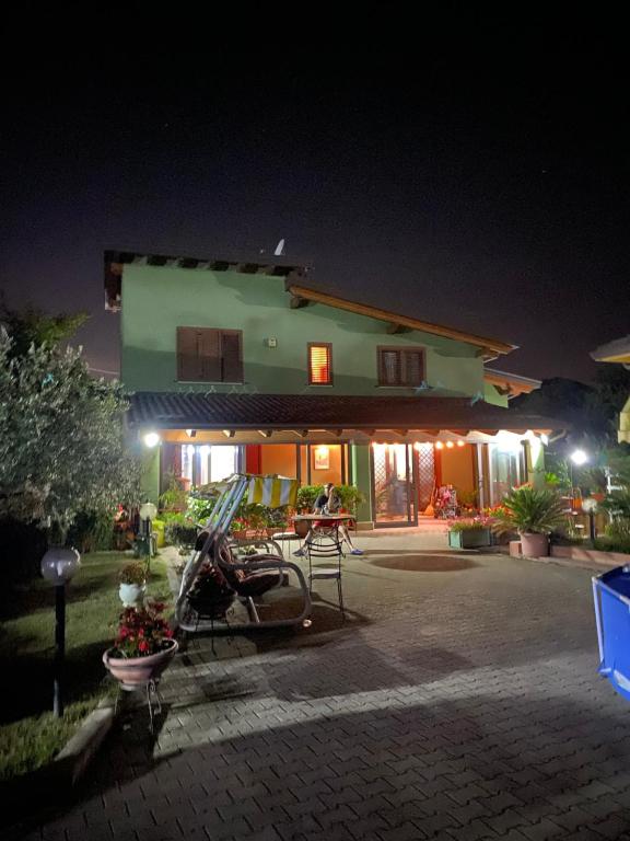a house with a motorcycle parked in front of it at night at B&B Santa Maria in Forino