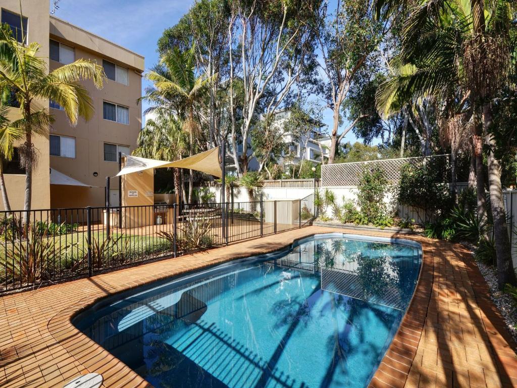 ホークス・ネストにあるAquarius Apartment 7の建物の前のプール