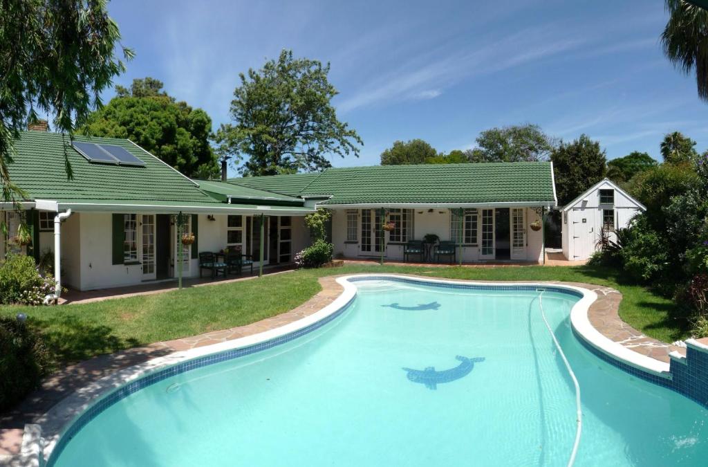 an image of a swimming pool in front of a house at Somer Place B&B in Somerset West