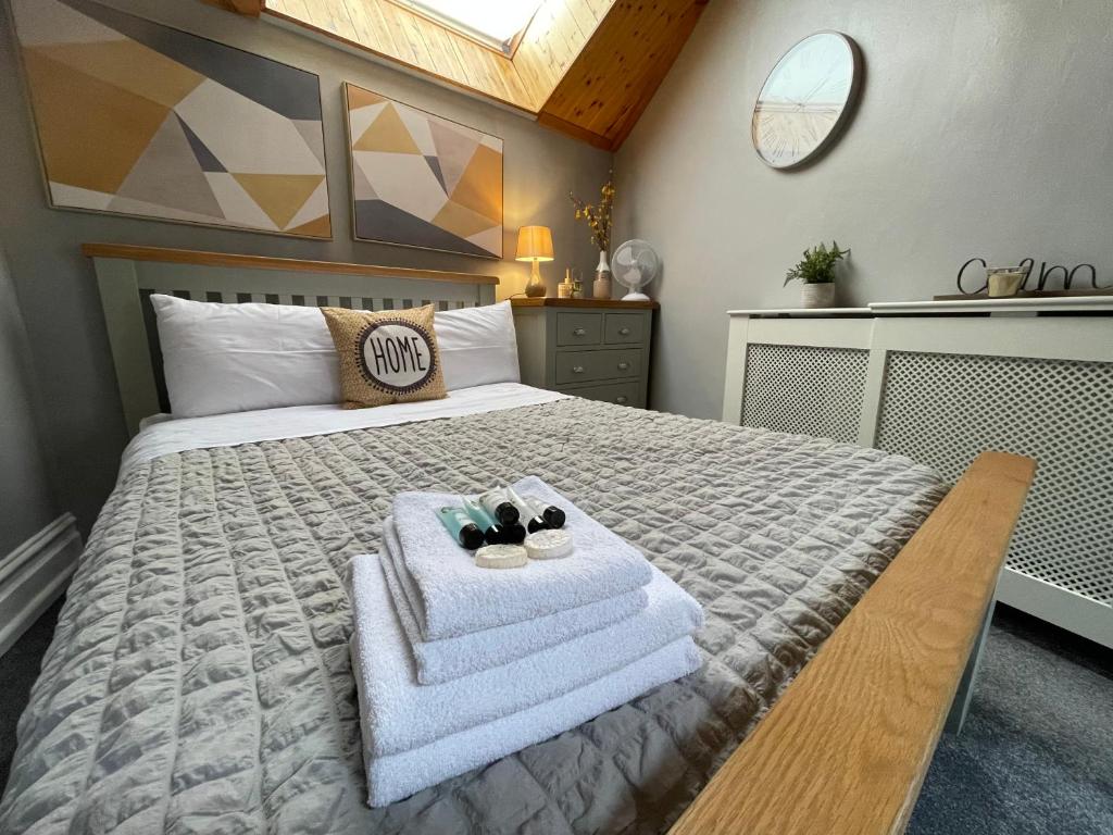a bedroom with a bed with towels on it at Westend Holiday Room 1 Brecon - Shared Bathroom in Brecon