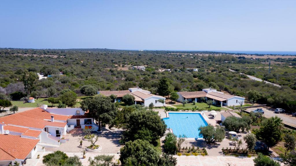 an aerial view of a resort with a swimming pool at Orosei Summer Holidays - Cala del Turco green house in Orosei