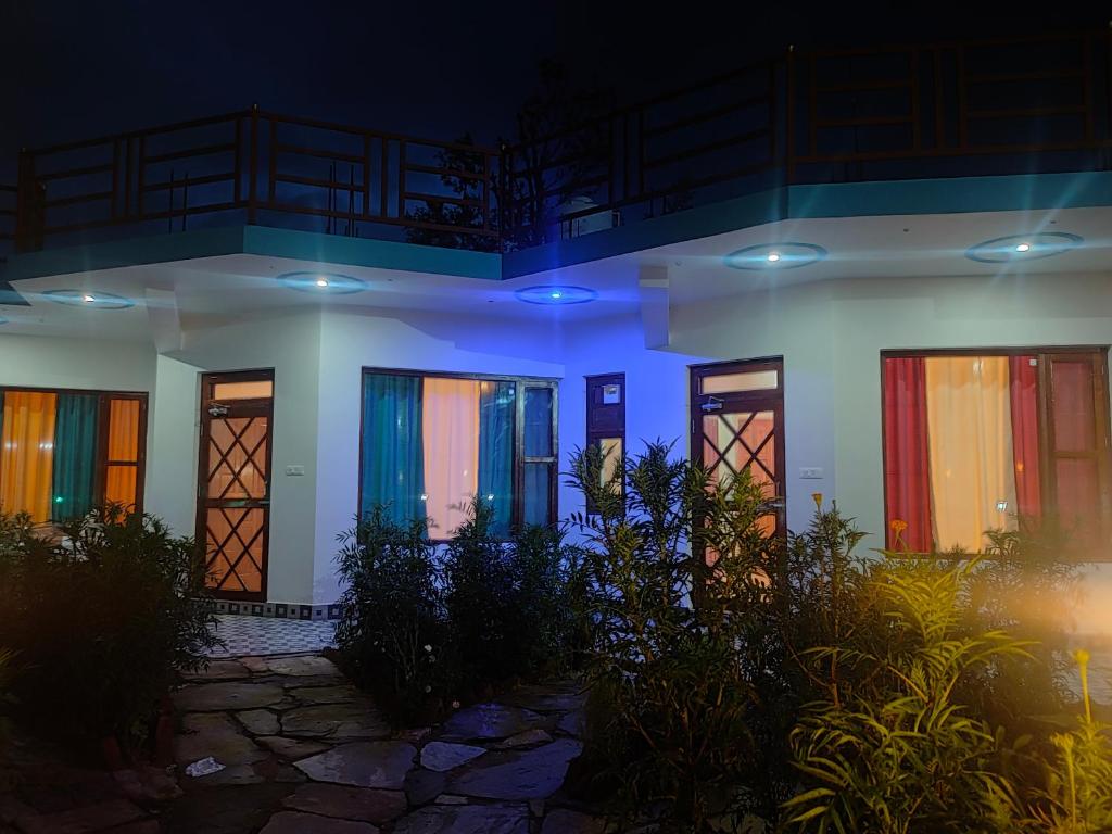 a house with colorful doors at night at Kasar wonder hill homestay in Almora