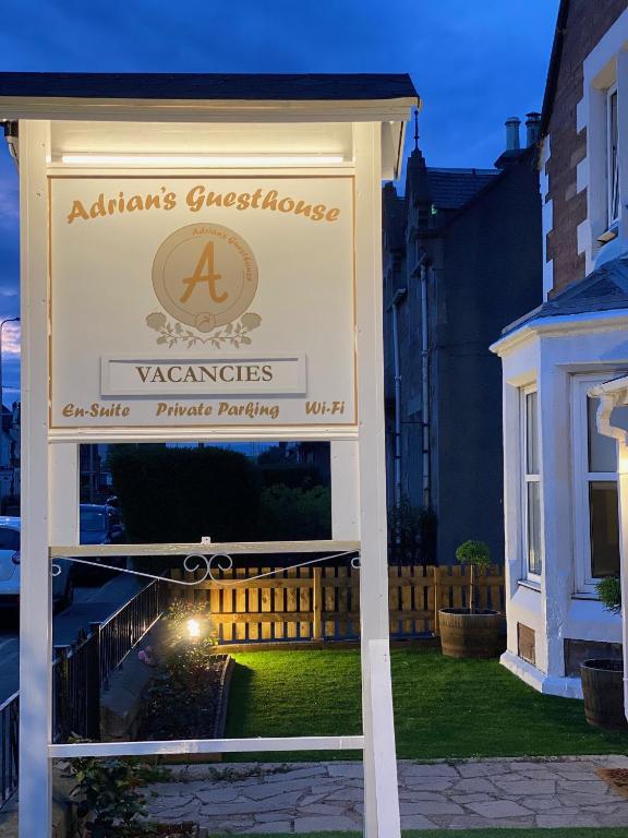 a sign for a victorian house in a yard at Adrian's Guest House in Inverness