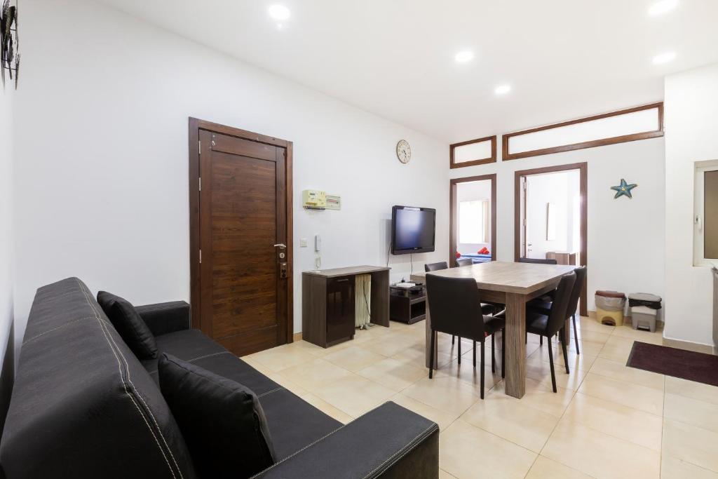 ein Wohnzimmer mit einem Sofa und einem Tisch in der Unterkunft PC3- Centrally Located Apt-Close to University in Msida