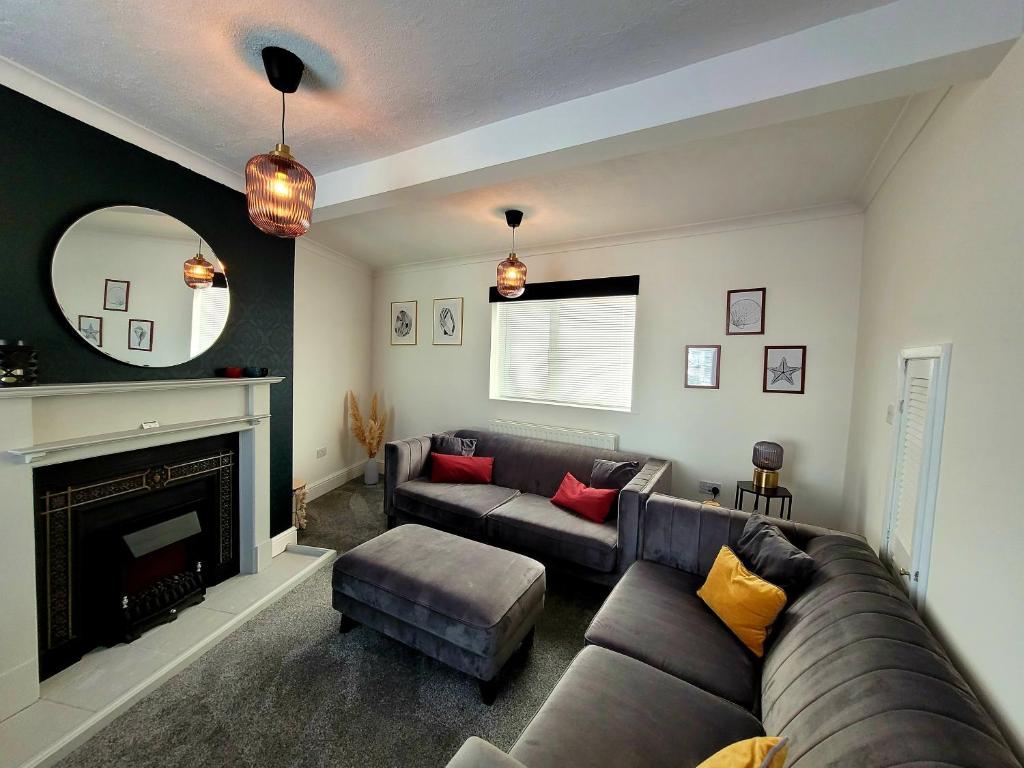a living room with a couch and a fireplace at The little seaside cottage in Bridlington