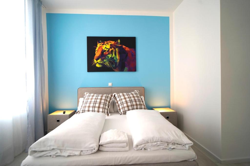 a bedroom with a bed with a painting of a horse at Hotel Böke Rheinfelden in Rheinfelden