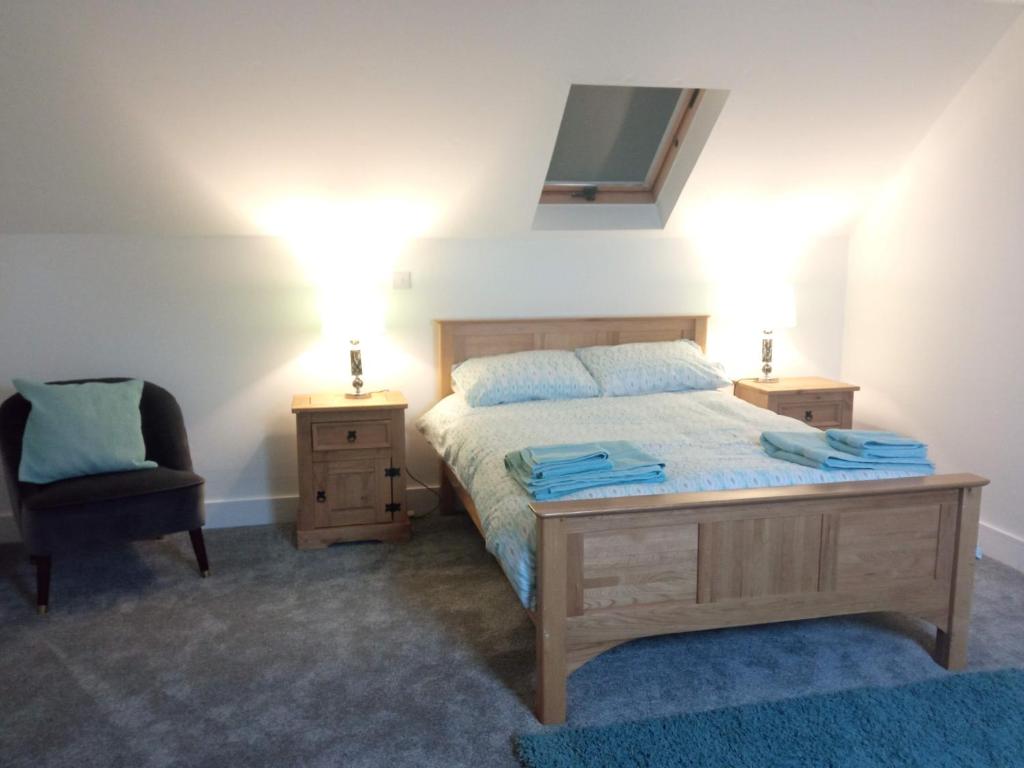 a bedroom with a bed and a desk and a chair at Greenway Guesthouse in Mullingar