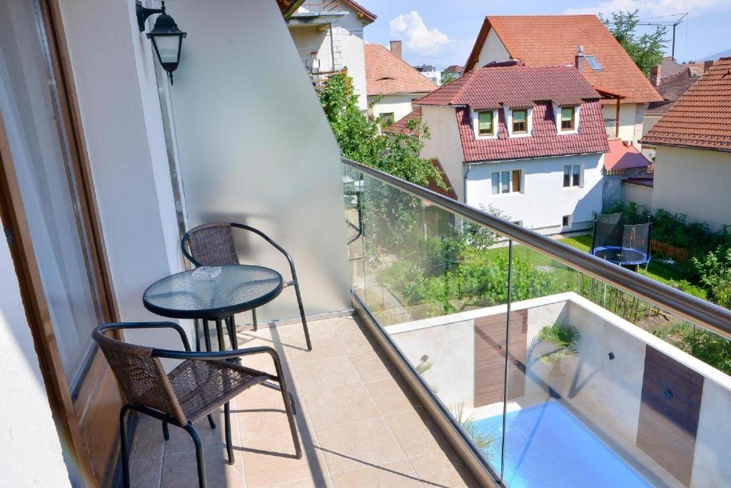 a balcony with a table and chairs and a view at Boutique Damiani in Sibiu