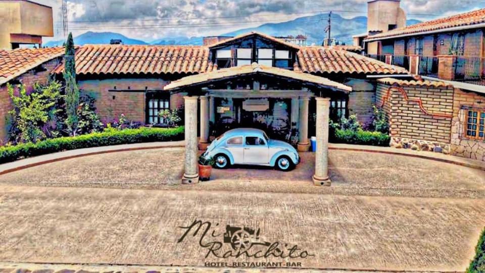 a car parked under a gazebo in a house at Mi Ranchito Chignahuapan Hotel in Chignahuapan
