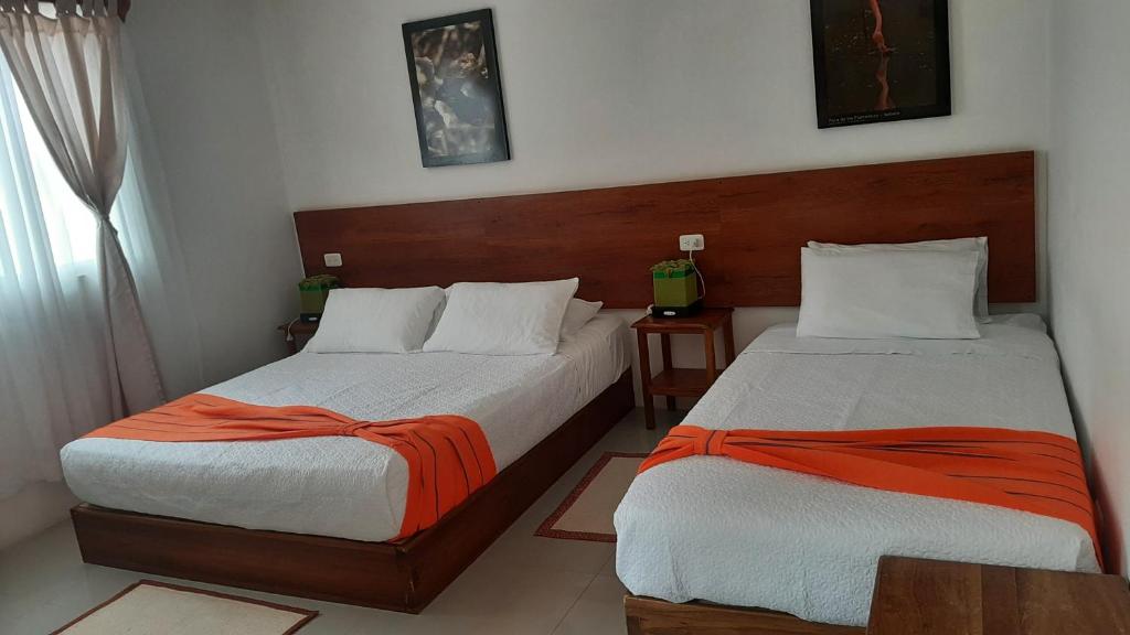 Postel nebo postele na pokoji v ubytování HOSTAL TERO REAL