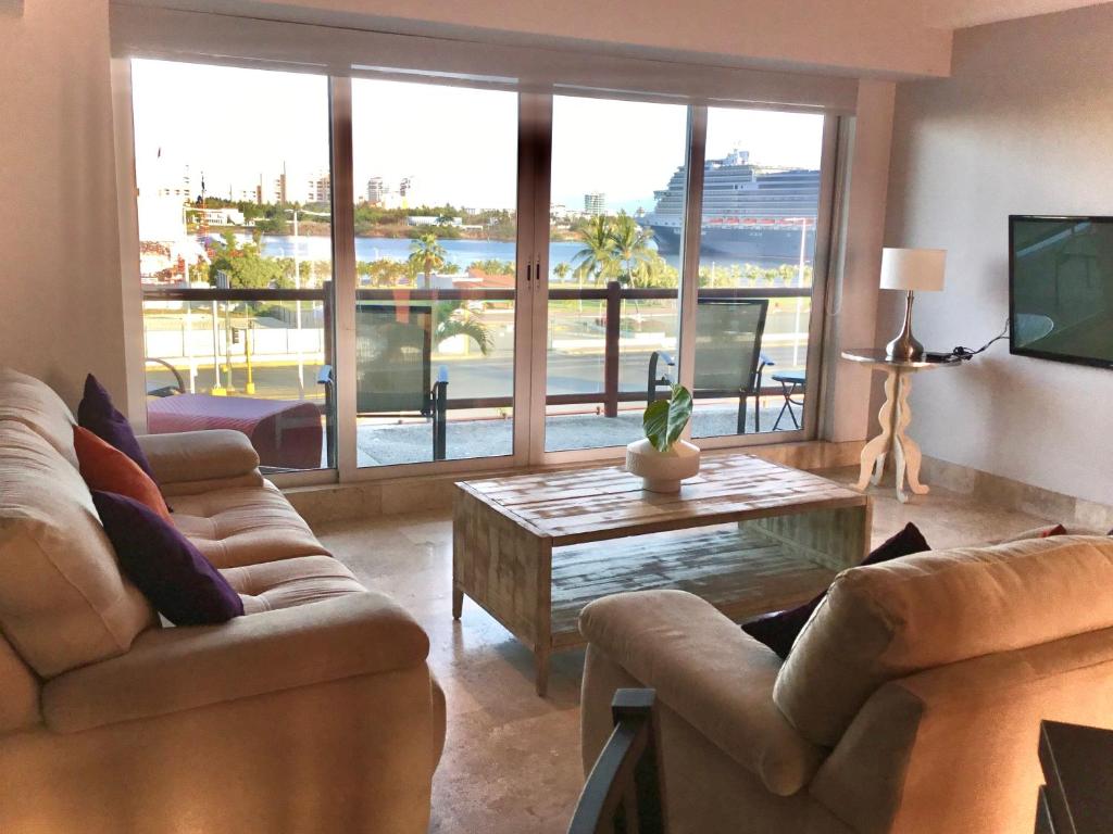 a living room with two couches and a coffee table at Oceanview Luxury, Pool, Near Tour Boats & Beach in Puerto Vallarta