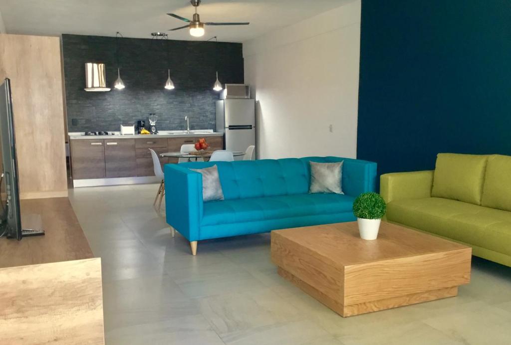 a living room with a blue couch and a table at One Bedroom Condo Near Beach RG6 in Puerto Vallarta