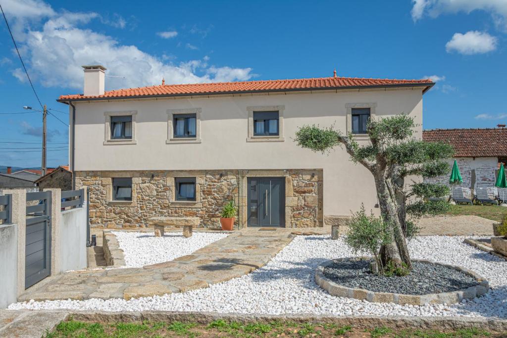 a house with a tree in front of it at Refúgio Da Gandra in Vila Nova de Cerveira