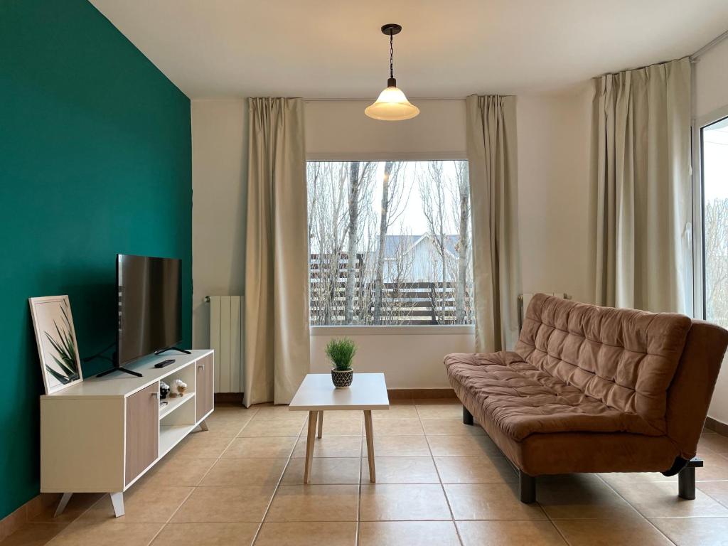 a living room with a couch and a television at South Apartments in El Calafate