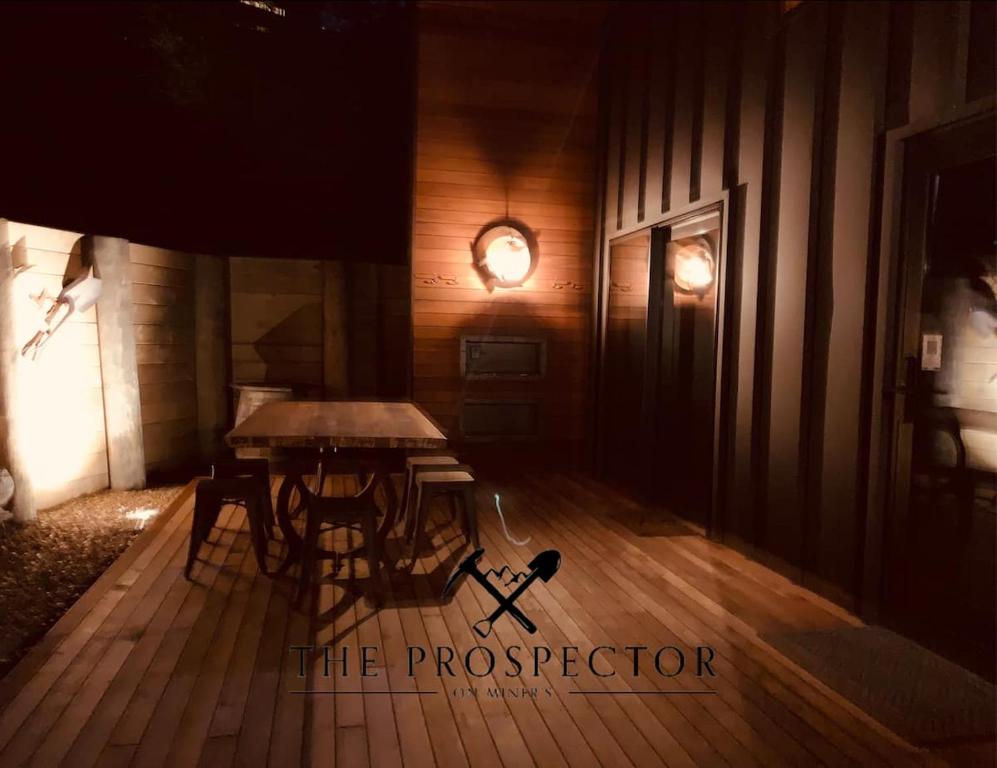 a room with a table and a wooden floor at The Prospector on Miners in Clyde