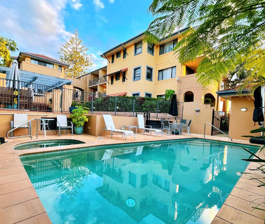 a swimming pool in front of a building at Mermaid Beach Park View in Gold Coast