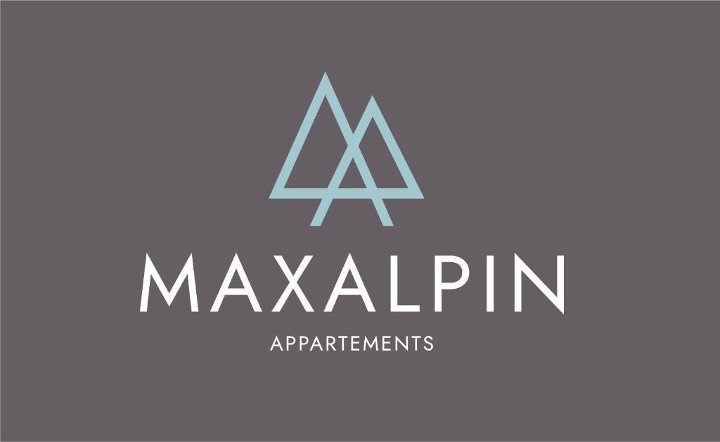 a logo for a manufacturing company with the initials ak majin at MAXAlpin Appartements in Längenfeld