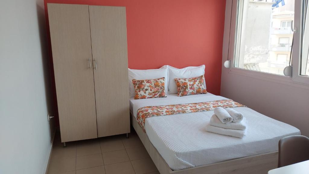 a small bedroom with a bed with towels on it at Kapsouli Square Komotini in Komotini