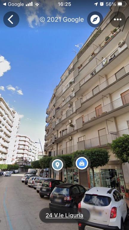 Hotel Taras holiday house, a street with cars parked in front of a building at Taras holiday house in Taranto