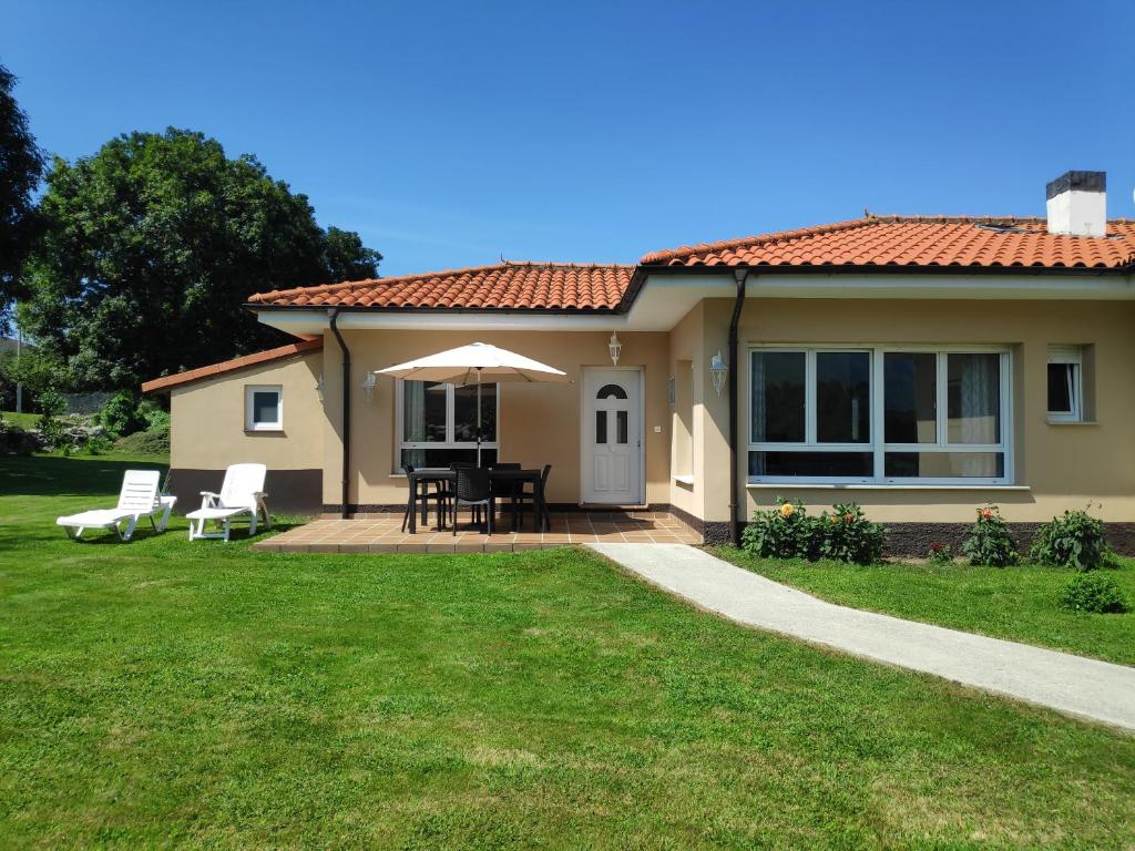 a house with a patio and a table and chairs at El Cerrón in Llanes