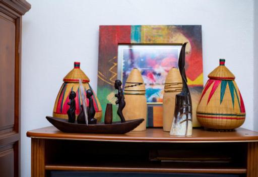 a table with a group of vases on it at Judith Home FIKA CAFE in Kigali