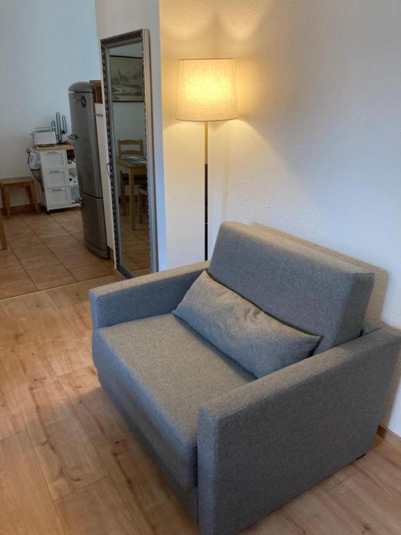 a blue couch sitting in a living room with a lamp at Premium City Apartment Dresden in Dresden