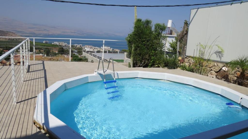 a large swimming pool in a patio with a view at Beit Nofesh in Tiberias