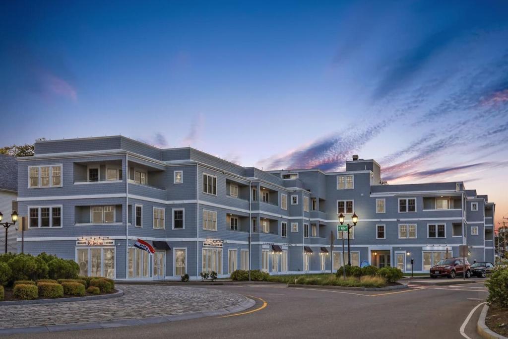 a large blue building in front of a street at Harbourtown Suites on Plymouth Harbor in Plymouth