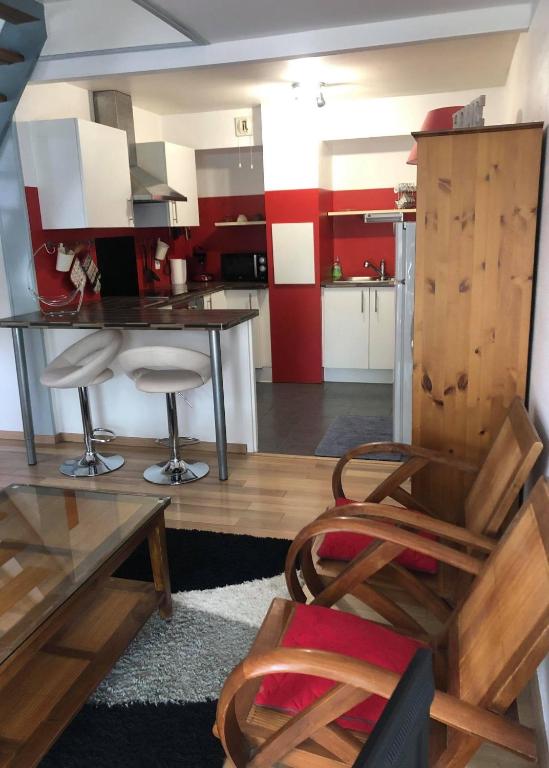 a kitchen with a table and chairs in a room at les magnolias in Colmar