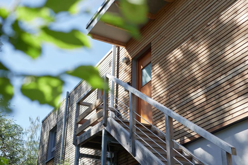 a house with a wooden staircase on the side of it at Penthouse one in Wilnsdorf