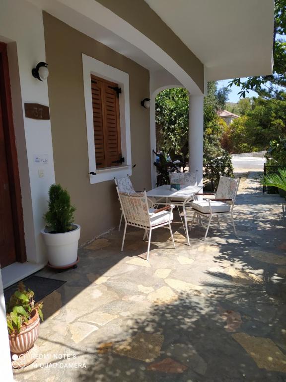 a patio with chairs and a table on a house at Makis Rooms Katelios in Katelios