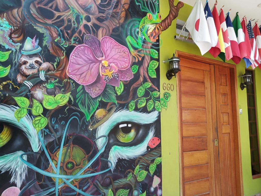 a wall with a colorful painting on it at Moicca Hostel in Iquitos