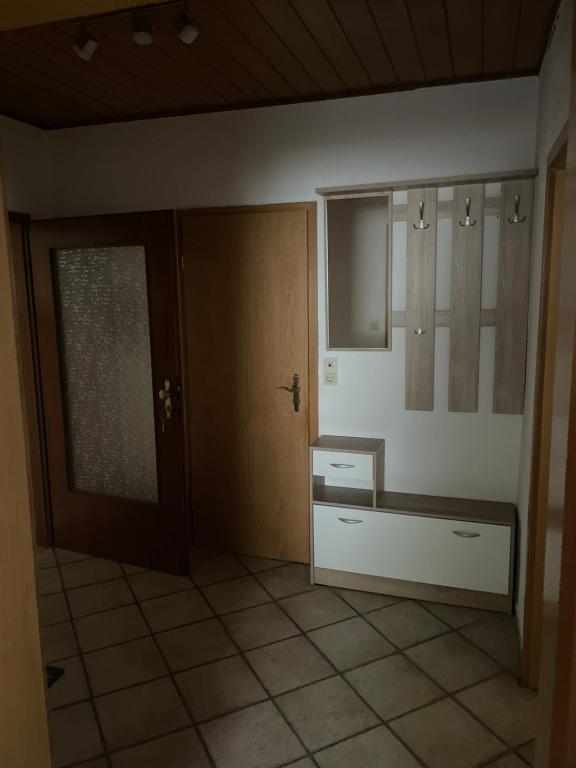 a room with a door and a tiled floor at Erlenstr. 17 35410 Hungen in Hungen