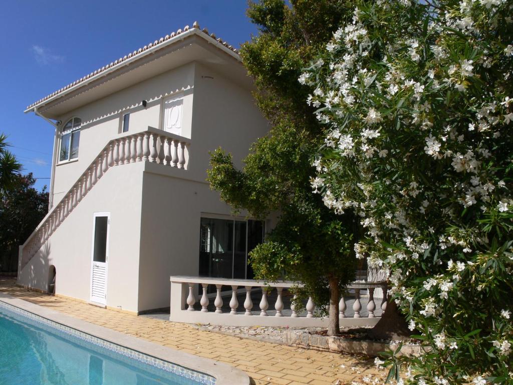 a house with a swimming pool in front of it at Beach House Lagos - Beachhouselagos - Meia Praia in Lagos