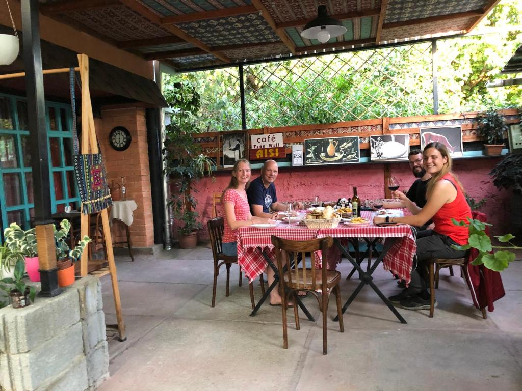un grupo de personas sentadas en una mesa en un restaurante en Guesthouse AISI in Lagodekhi, en Lagodeji