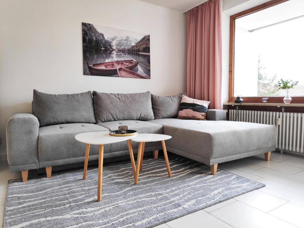 a living room with a couch and a table at Ferienwohnung Alpenglück im Allgäu in Missen-Wilhams