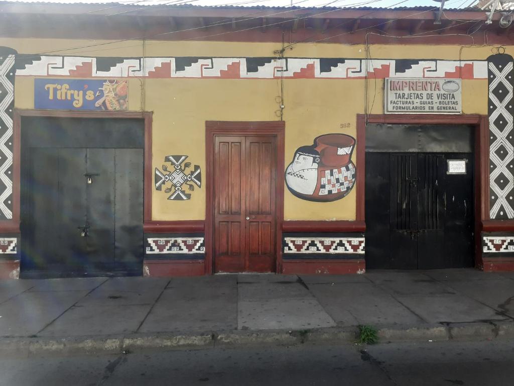 a building with three doors on the side of it at Tifrys in La Serena