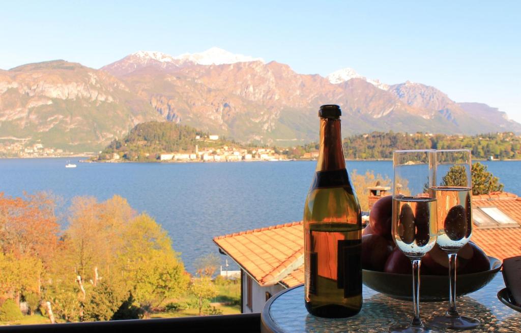 a bottle of wine sitting on a table with two glasses at Cadenabbia Fantastico in Griante Cadenabbia