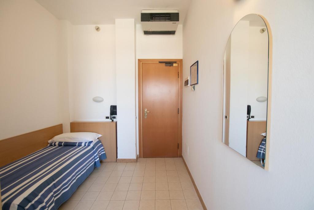 Postel nebo postele na pokoji v ubytování Piccolo Hotel